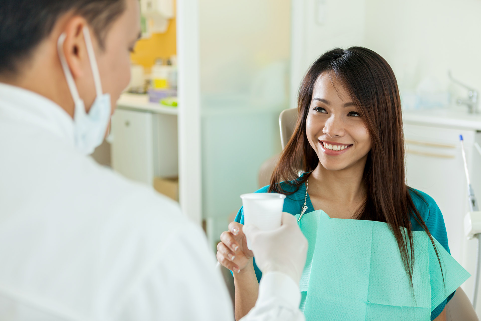 Dental nurse with mouthwash
